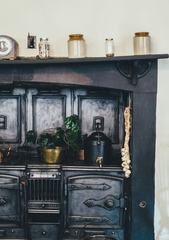 Folk medicine bottles and items on an old kitchen stove