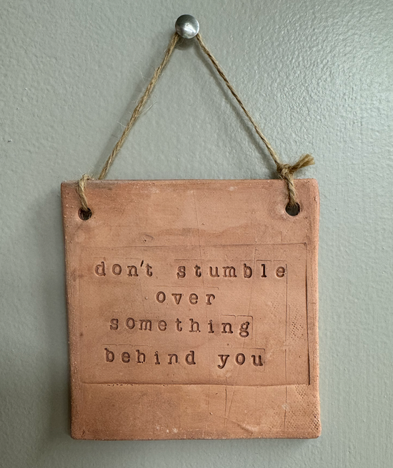 "Don't stumble over something behind you" Wall Hanging Tile